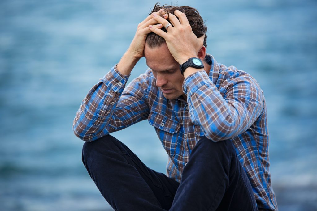 worried man with hands on his head